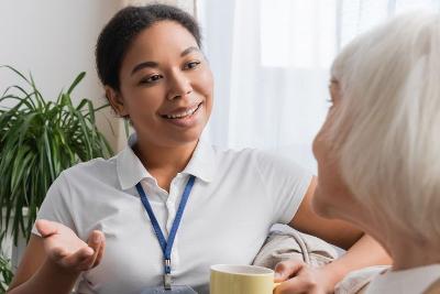 Carer chatting with older woman