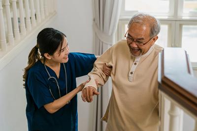 Carer helping patient on stairs